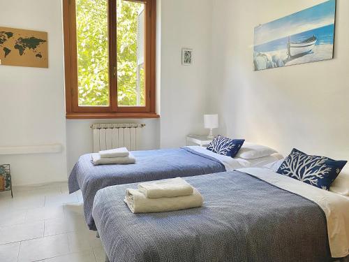 a bedroom with two beds with towels on them at Ca del Mare - FREE Parking in La Spezia