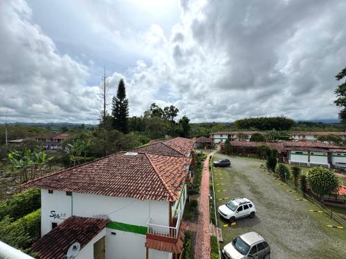 an aerial view of a house with cars parked in a driveway at Ecohotel Santa Barbara in Circasia