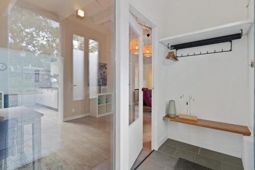 a hallway of a home with a glass door at Boerderijwoning 't Boetje in Heiloo