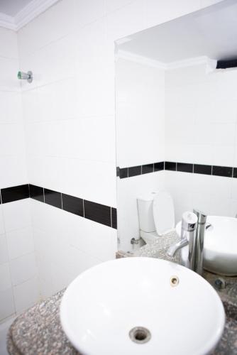 a bathroom with a white sink and a mirror at Dahab Hostel in Cairo