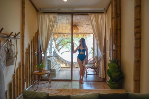 a woman in a blue bathing suit standing in a room at Bamboo Seaview Koh Larn Second Floor - 2nd Floor in Ko Sak