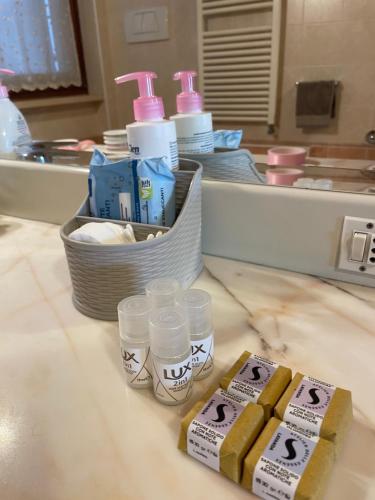 a bathroom counter with toothbrushes and cups on a counter at Villa Rondine in Corno Alto