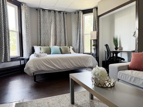a living room with a bed and a couch at Chandler Studio Apartments in Evansville