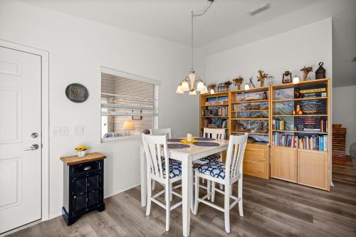 a dining room with a white table and chairs at Sunnyside Escape in The Villages With Golf Cart & BBQ in The Villages