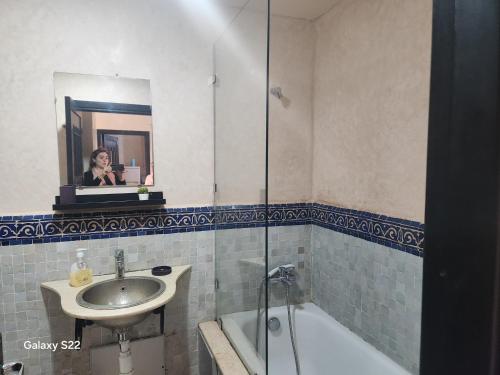a woman taking a picture in a bathroom mirror at Atlas golf in Marrakech