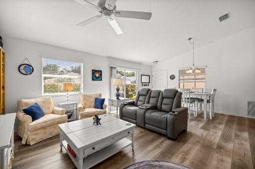 a living room with a couch and a table at Sunnyside Escape in The Villages With Golf Cart & BBQ in The Villages