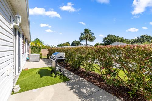 a house with a generator next to a yard at Sunnyside Escape in The Villages With Golf Cart & BBQ in The Villages