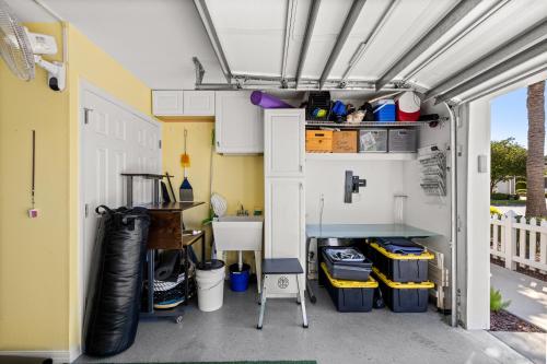 an inside view of a garage with a garage door open at Sunnyside Escape in The Villages With Golf Cart & BBQ in The Villages