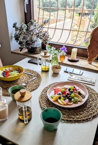 a table with a plate of food on it at Mas Oms in Montnegre