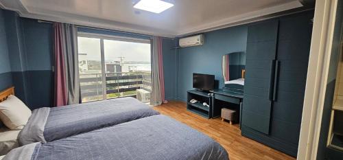 Ένα ή περισσότερα κρεβάτια σε δωμάτιο στο jeju Tovice Condo Ocean
