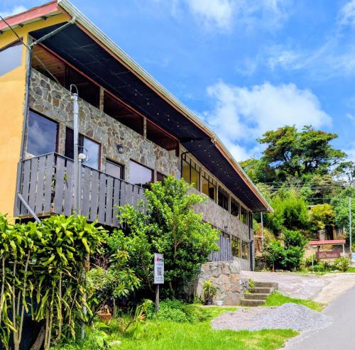 a building with a stone facade with windows at Miztli Lodge & Adventure in Monteverde Costa Rica