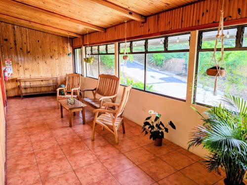 a living room with two chairs and a table at Miztli Lodge & Adventure in Monteverde Costa Rica