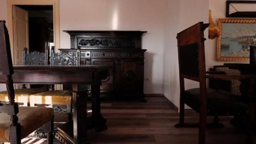 a room with a wooden table and a piano at Il Casolare in San Giovanni Teatino