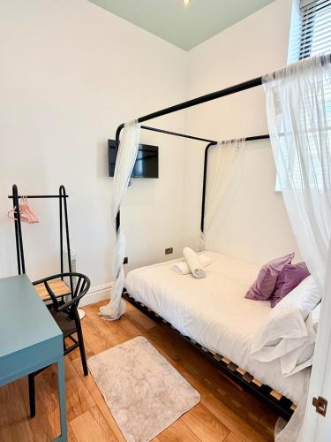 a bedroom with a bed with a canopy at The City Nest - Sleeps 7 - Free Off Street Parking in Bristol