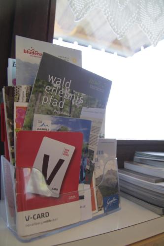 a stack of books sitting on top of a table at Urlaub am Obermahd in Ludescherberg