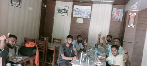 a group of men sitting at a table in a restaurant at The Mrityunjaya Palace Guptakashi in Gupta Kāshi