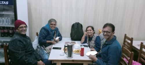 a group of people sitting at a table eating food at The Mrityunjaya Palace Guptakashi in Gupta Kāshi