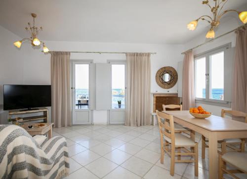 a living room with a table and a dining room at Christiana Hotel in Ambelas