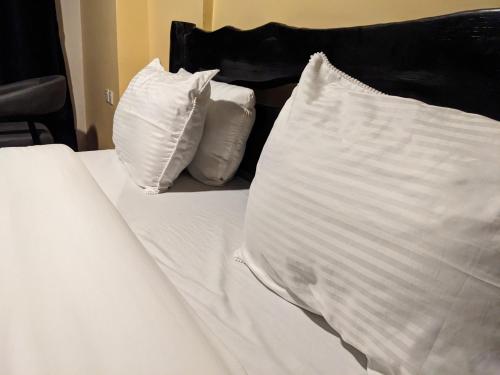 Ένα ή περισσότερα κρεβάτια σε δωμάτιο στο UMUGANO House Inn