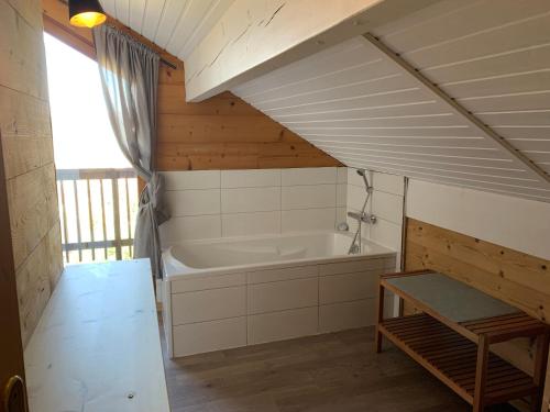 a bathroom with a bath tub in a room at Chalet Gaby - chalet atypique avec SPA in Xonrupt-Longemer