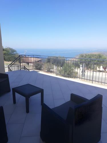 a balcony with a table and a bench and a view at Dente Di Leone in San Mauro Cilento