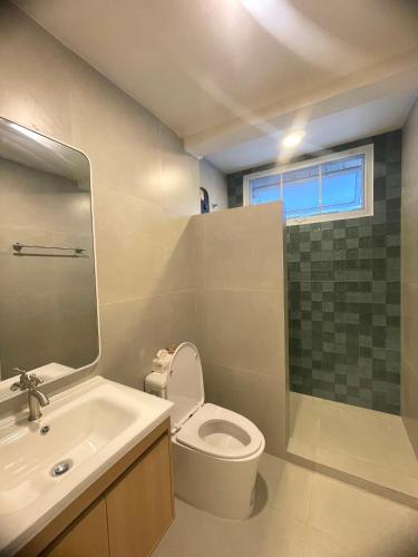 a bathroom with a toilet and a sink and a shower at บ้านช่วงเวลาหนึ่ง - House of Moment in Chiang Rai