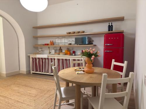 a kitchen with a table and a red refrigerator at Casa Del Re in Tufo