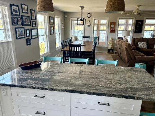 a kitchen and living room with a large marble counter top at Island Time home in Holden Beach