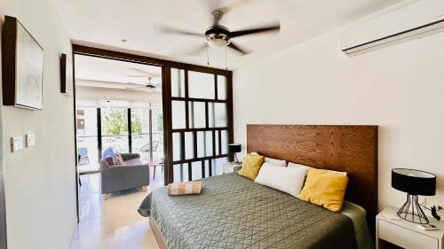a bedroom with a bed and a ceiling fan at Ipana Luxury Suites By Caribe Rentas in Playa del Carmen
