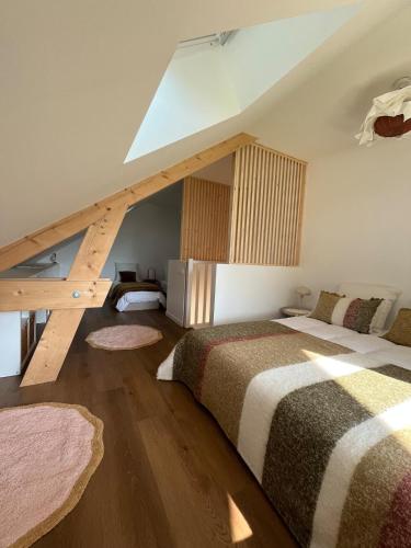 a attic bedroom with two beds and a skylight at HÔME Les hauts du Val in Vantoux