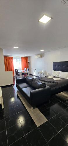 two beds in a room with a living room at Original Apartments in Albufeira