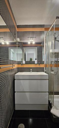 a bathroom with a white sink and a shower at Original Apartments in Albufeira