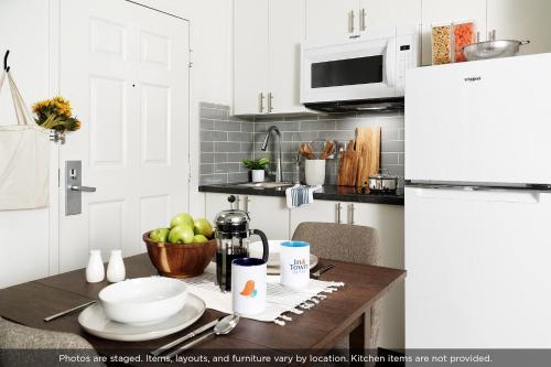 a kitchen with a table with a bowl of apples at InTown Suites Extended Stay Houston TX - Highway 6 in Houston