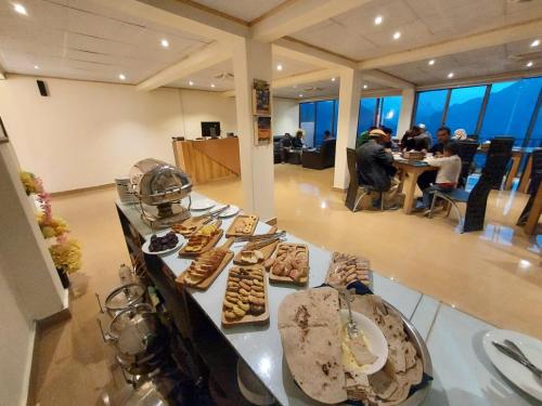 Una línea de buffet con diferentes tipos de pasteles. en Hunza Hard Rock Resort, en Baltit