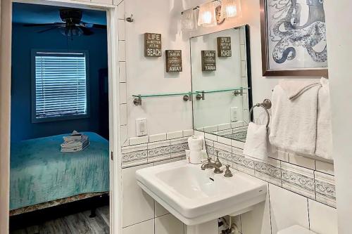 a bathroom with a sink and a mirror at Neptunes Palace A1 in Saint George Island