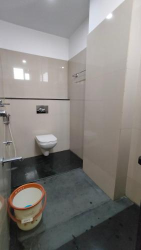 a bathroom with a toilet and a toilet bowl at Embassy Grand in Jāmb