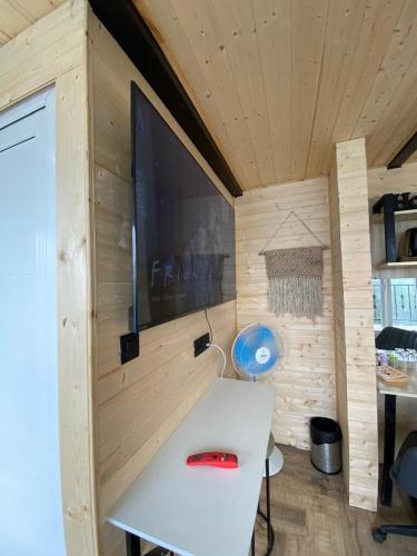 a small room with a table and a tv on a wall at The Kiana's in Mussoorie