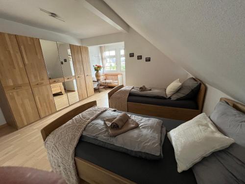 a bedroom with two beds and a mirror at Villa-Maru 80qm Ferienwohnung in Lindlar