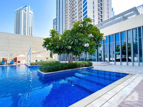 a swimming pool in the middle of a building with tall buildings at Luxurious Creek Harbour Apt with Balcony & View in Dubai