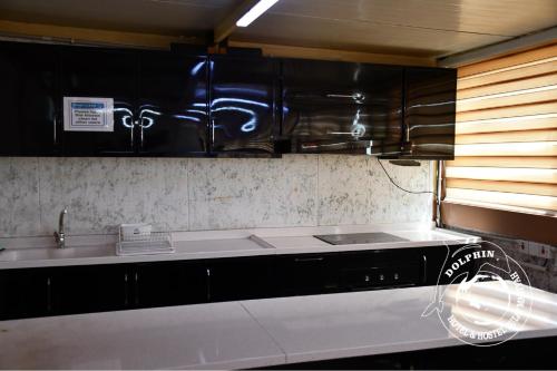 a kitchen with a sink and a counter top at Dolphin Hotel & Hostel in As Sulaymānīyah