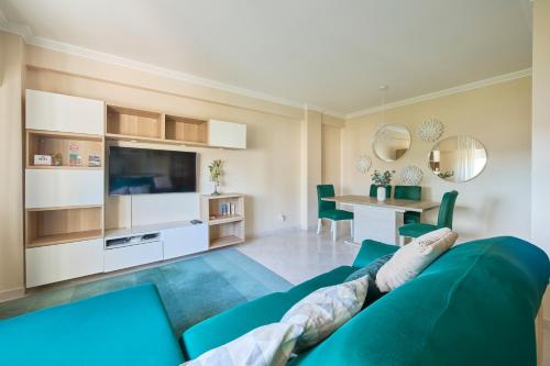 a living room with a blue couch and a table at CasaFernandes 15 - Premium stay in Lisbon in Odivelas