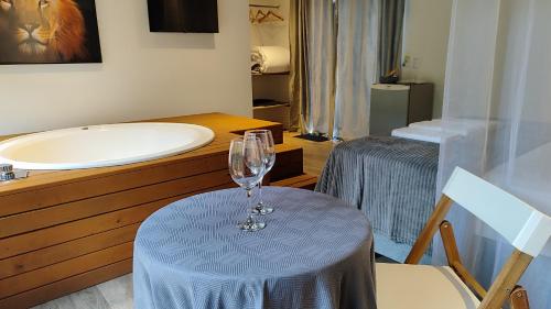 a bathroom with a table with a wine glass on it at Essência do Sol Pousada in Florianópolis