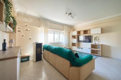 a living room with a couch and a television at CasaFernandes 15 - Premium stay in Lisbon in Odivelas