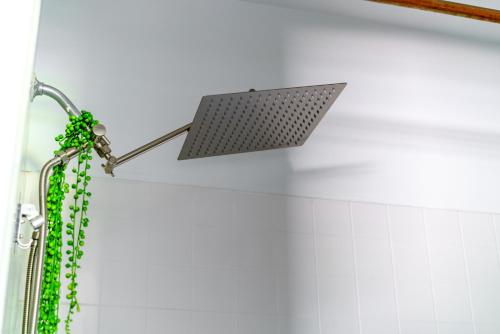 a shower with a light on the wall at Short North Convention Private Parking Pets in Columbus