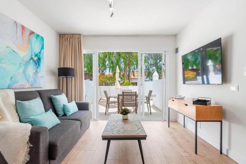 a living room with a couch and a table at Wyndham Residences Golf del Sur in San Miguel de Abona