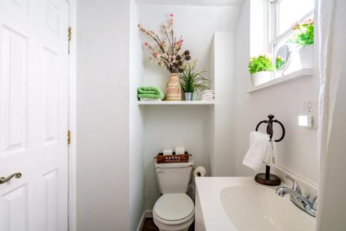 a white bathroom with a toilet and a sink at Short North Convention Private Parking Pets in Columbus