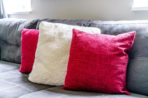 two red and white pillows on a gray couch at Short North Convention Private Parking Pets in Columbus
