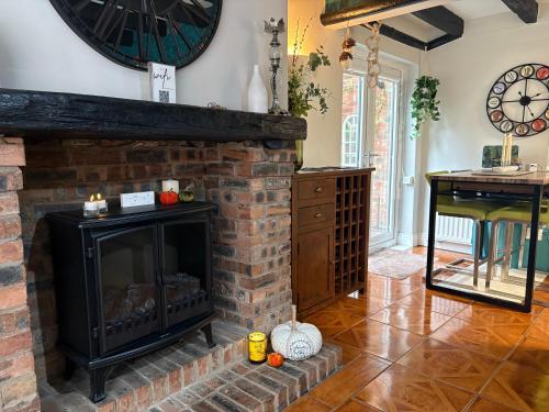 a living room with a fireplace with a clock on the wall at On Yarm High Street Great for Couples Families and Business Travel in Yarm