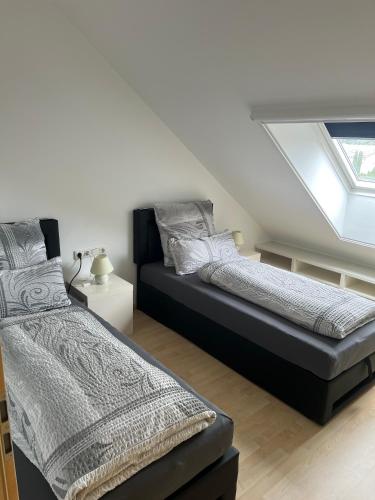 a bedroom with two beds and a window at Hinter-Apartments West in Rohrbach