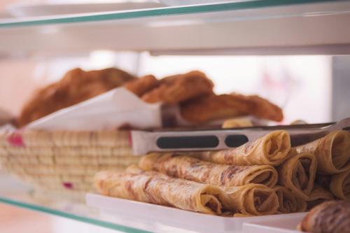 a display case filled with lots of different types of bread at Endless Wave Retreat in Agadir